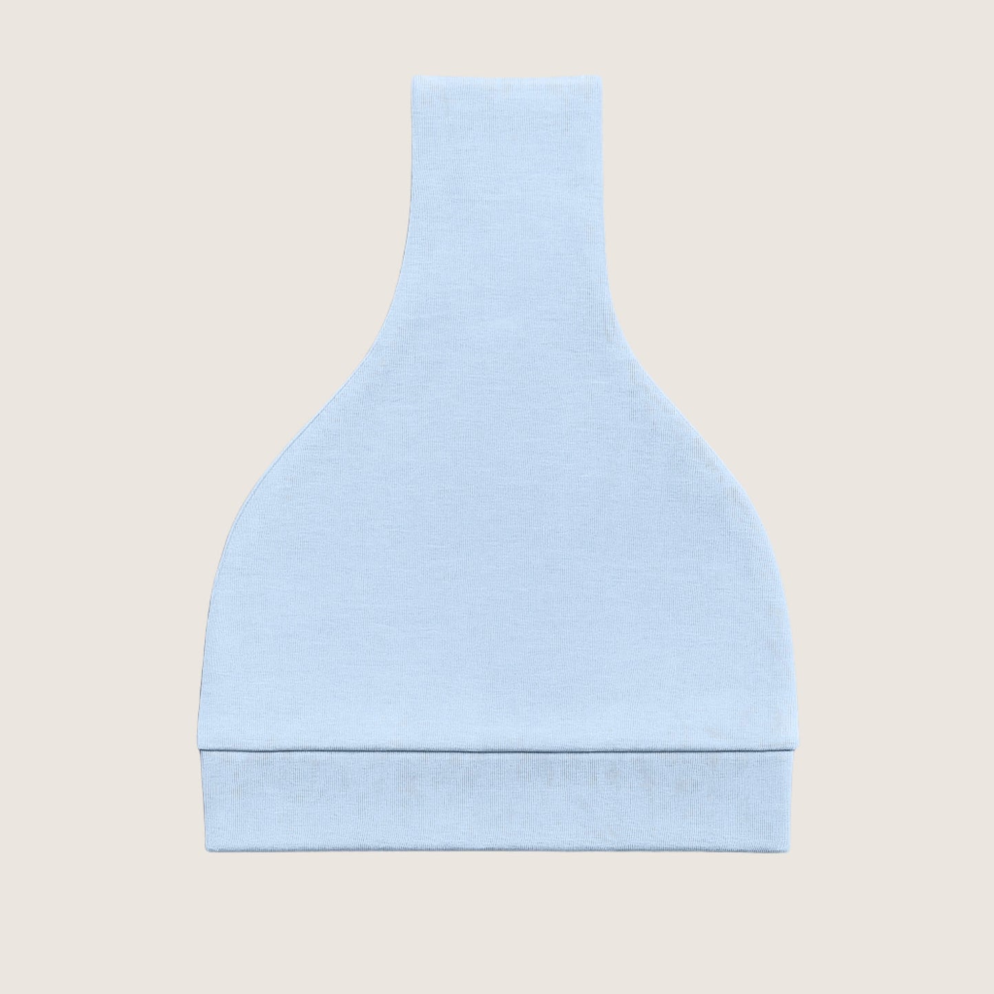 Light blue knotted hat folded on a beige background