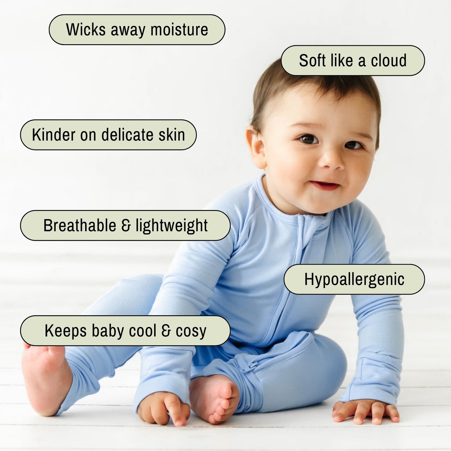 Baby wearing a light blue pyjamas sitting on floor
