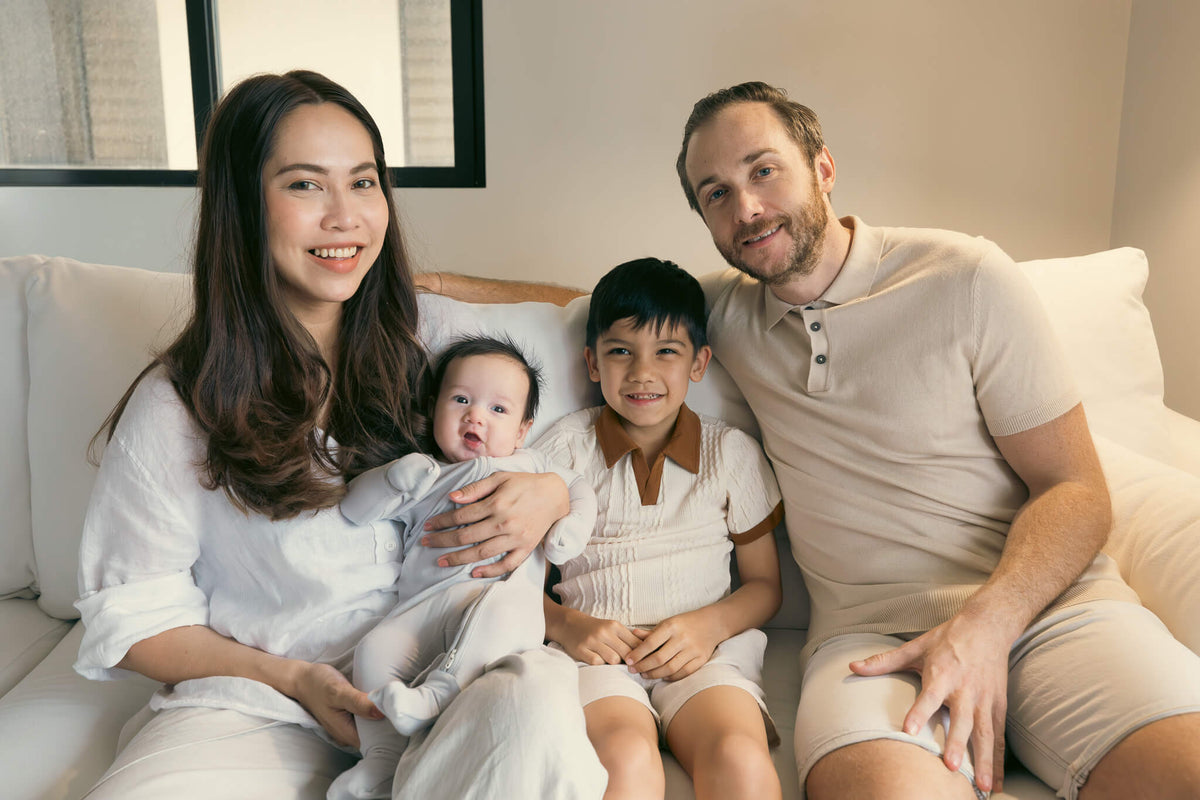 family sitting on white sofa
