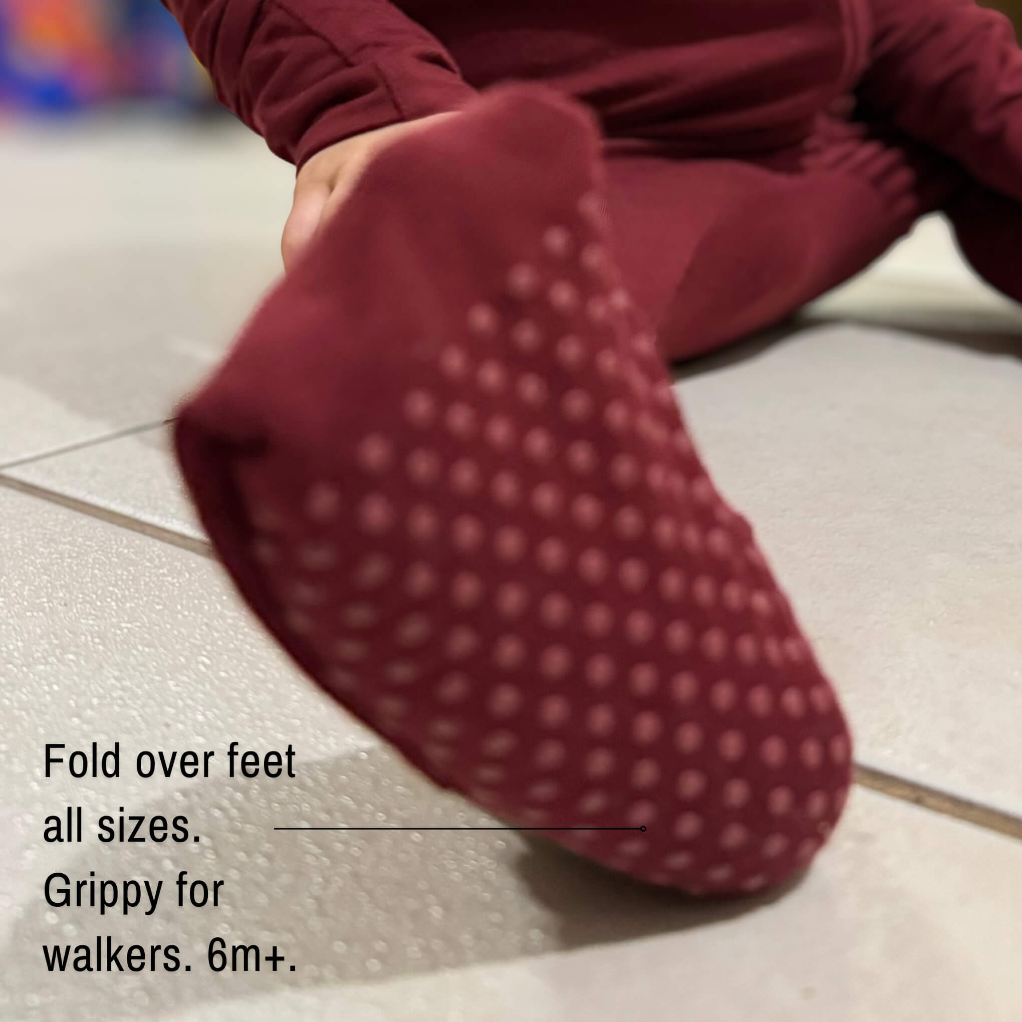 Close up off feet maroon bamboo baby grow