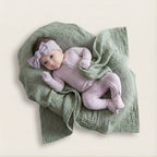 Baby girl waring lavender bow and baby grow