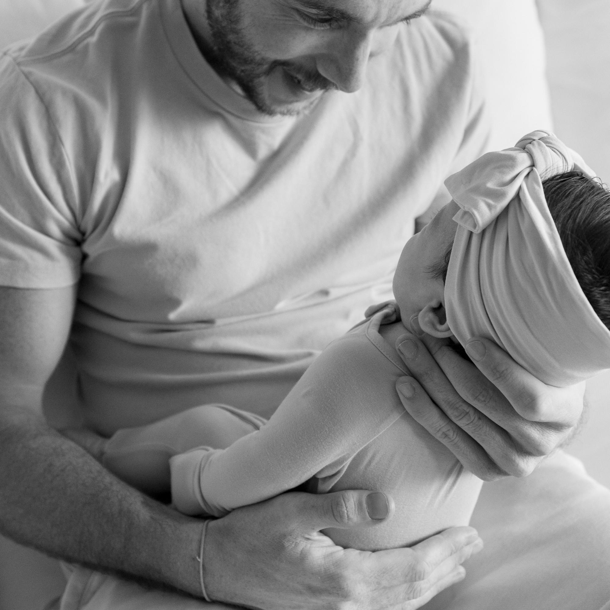 Black and white photo of a man holding a baby