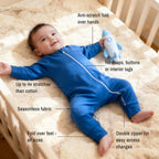 Baby wearing deep blue bamboo baby grow