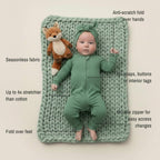 Baby in green bamboo baby grow