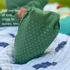 Close up of folded over feet on green bamboo baby grow