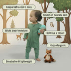 Baby in green bamboo baby grow holding a owl toy