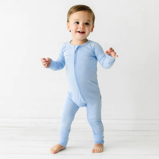 Toddler standing wearing light blue bamboo pyjamas