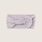 Light gray headband with a large bow on a beige background