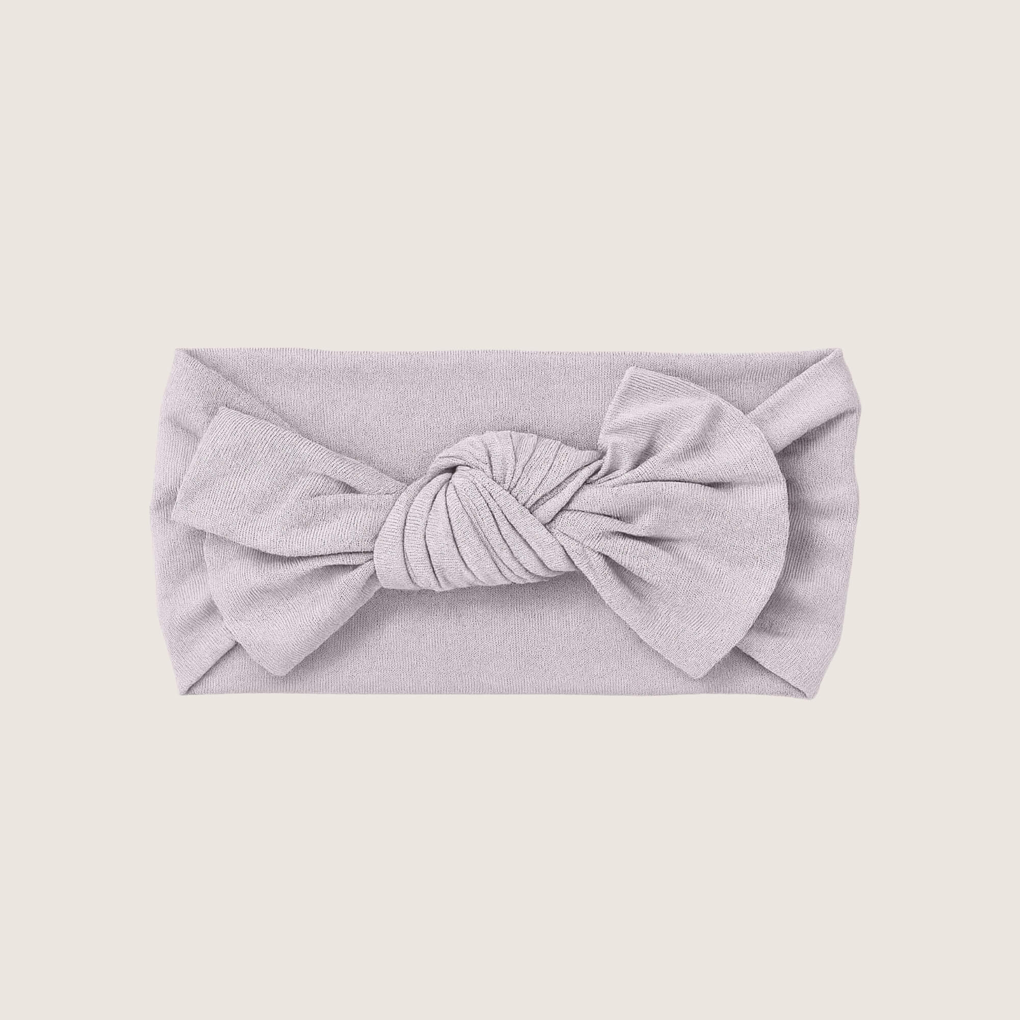 Light gray headband with a large bow on a beige background