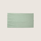 Green headband on a beige background