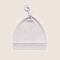 Grey baby hat with a knot on top against a light beige background