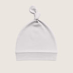 Grey baby hat with a knot on top against a light beige background