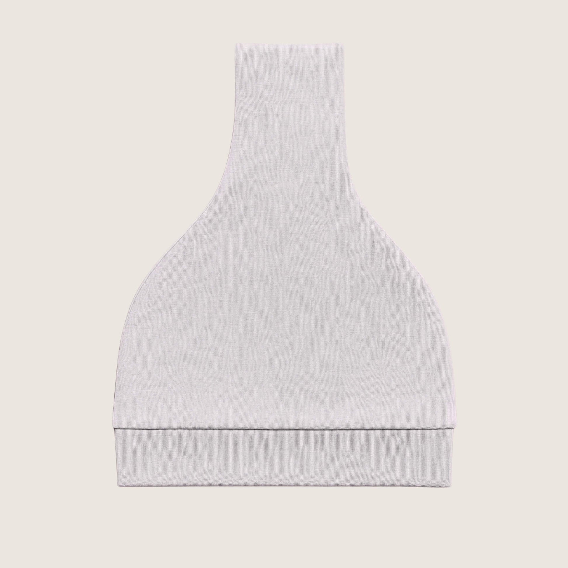 Grey baby hat with a knot on top folded against a light beige background