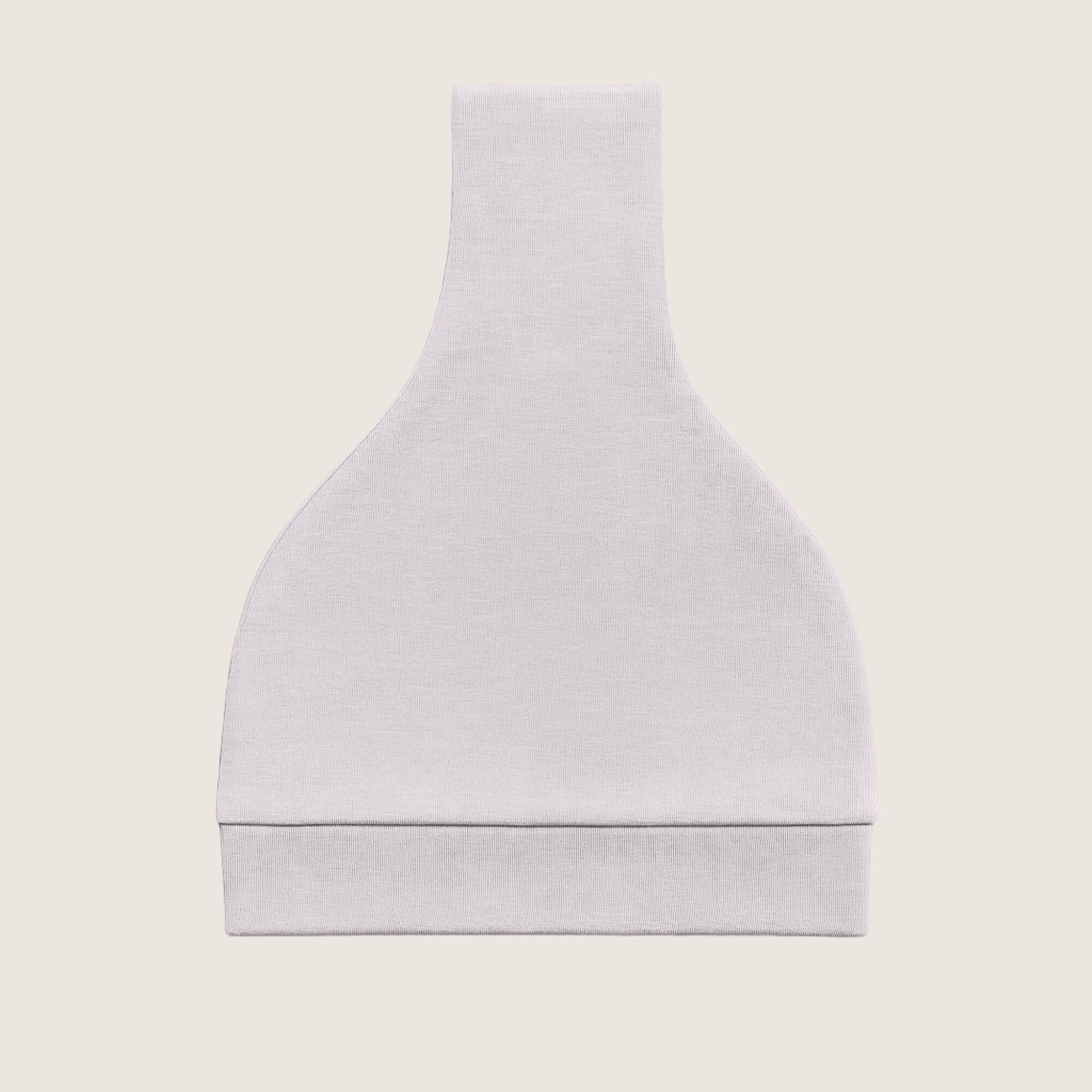 Grey baby hat with a knot on top folded against a light beige background