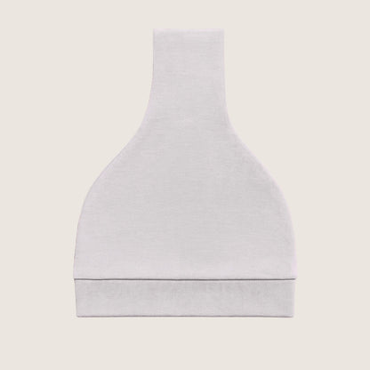 Grey baby hat with a knot on top folded against a light beige background