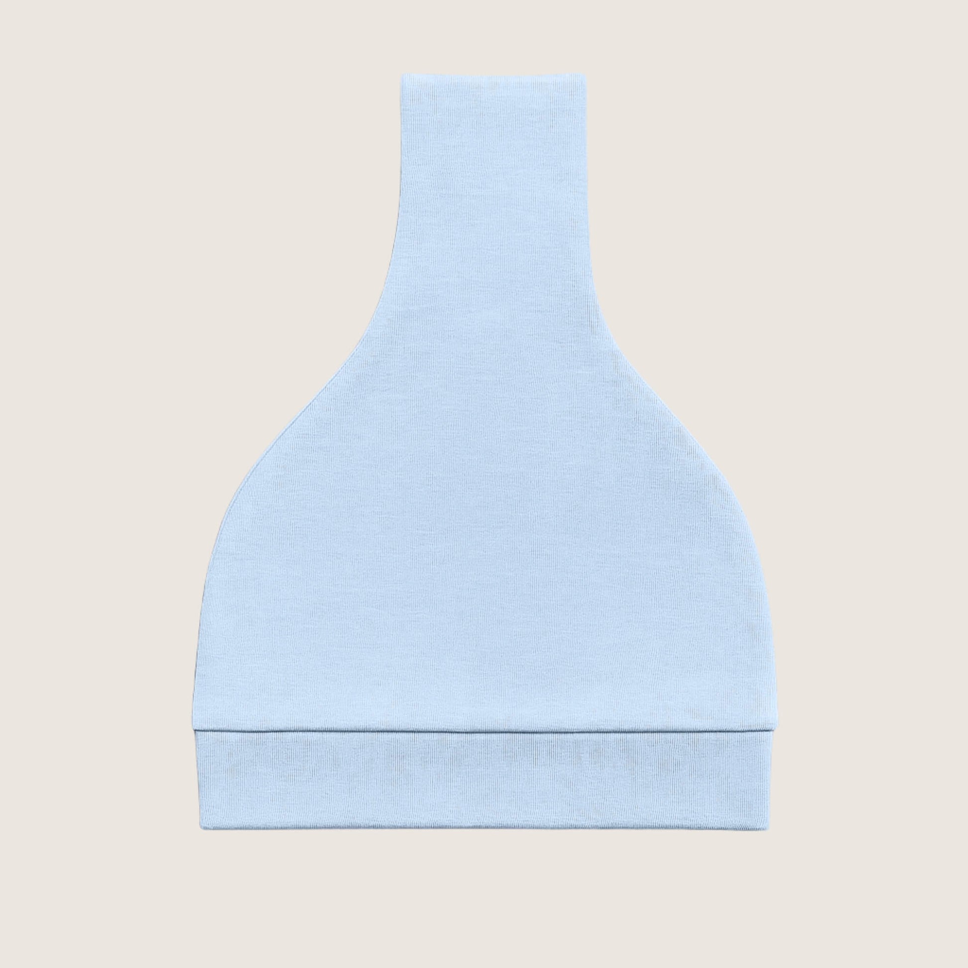 Light blue knotted hat folded on a beige background