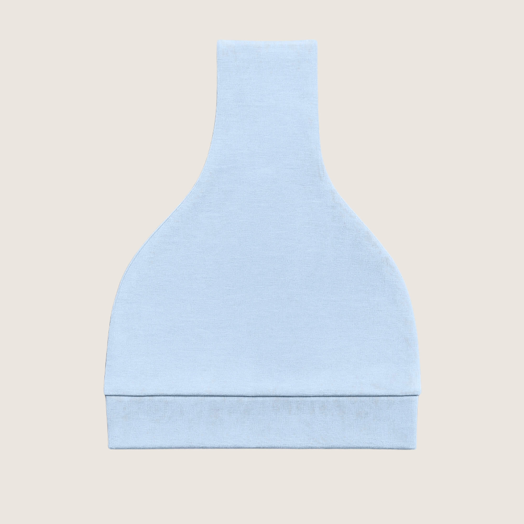 Light blue knotted hat folded on a beige background