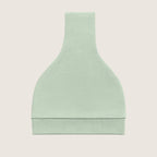 Mint green baby hat with a knot on top folded against a light beige background