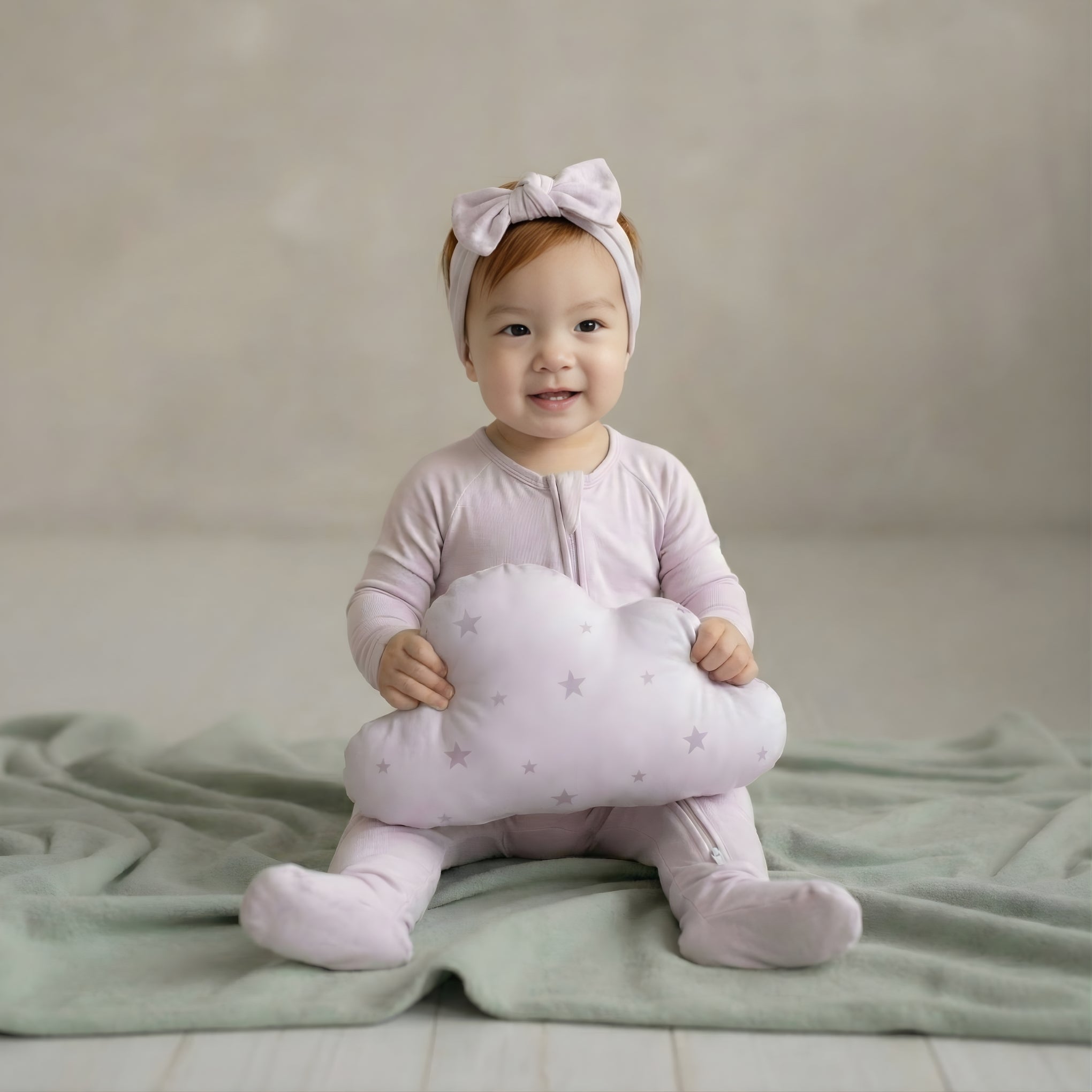 toddler girl wearing a lavender pyjamas sitting in studio