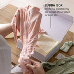 Mum opening box with pink baby pyjamas