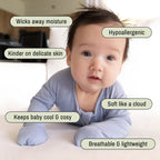 Baby wearing a blue pyjamas on tummy