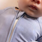 Baby wearing a blue pyjamas close up of zip
