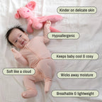 Baby wearing a pink bamboo pyjamas laying on white blanket