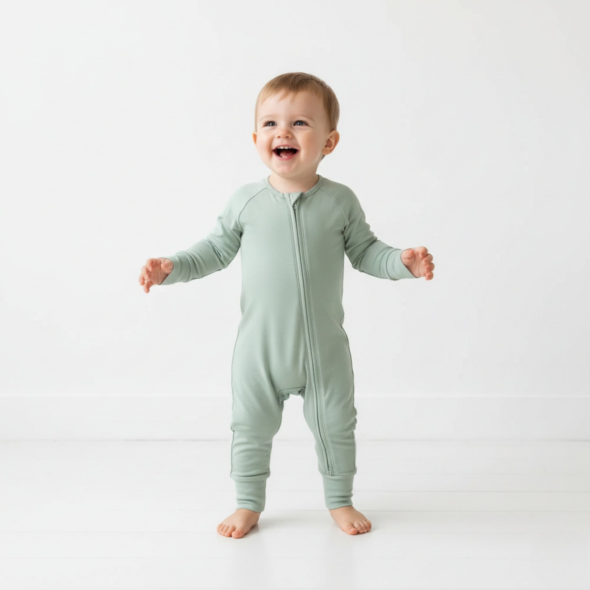 Boy wearing a green pyjamas standing up