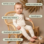 Toddler sitting in off white babygrow