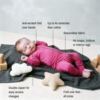 newborn girl sleeping wearing pink bamboo babygrow