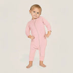 Baby wearing a pink baby grow