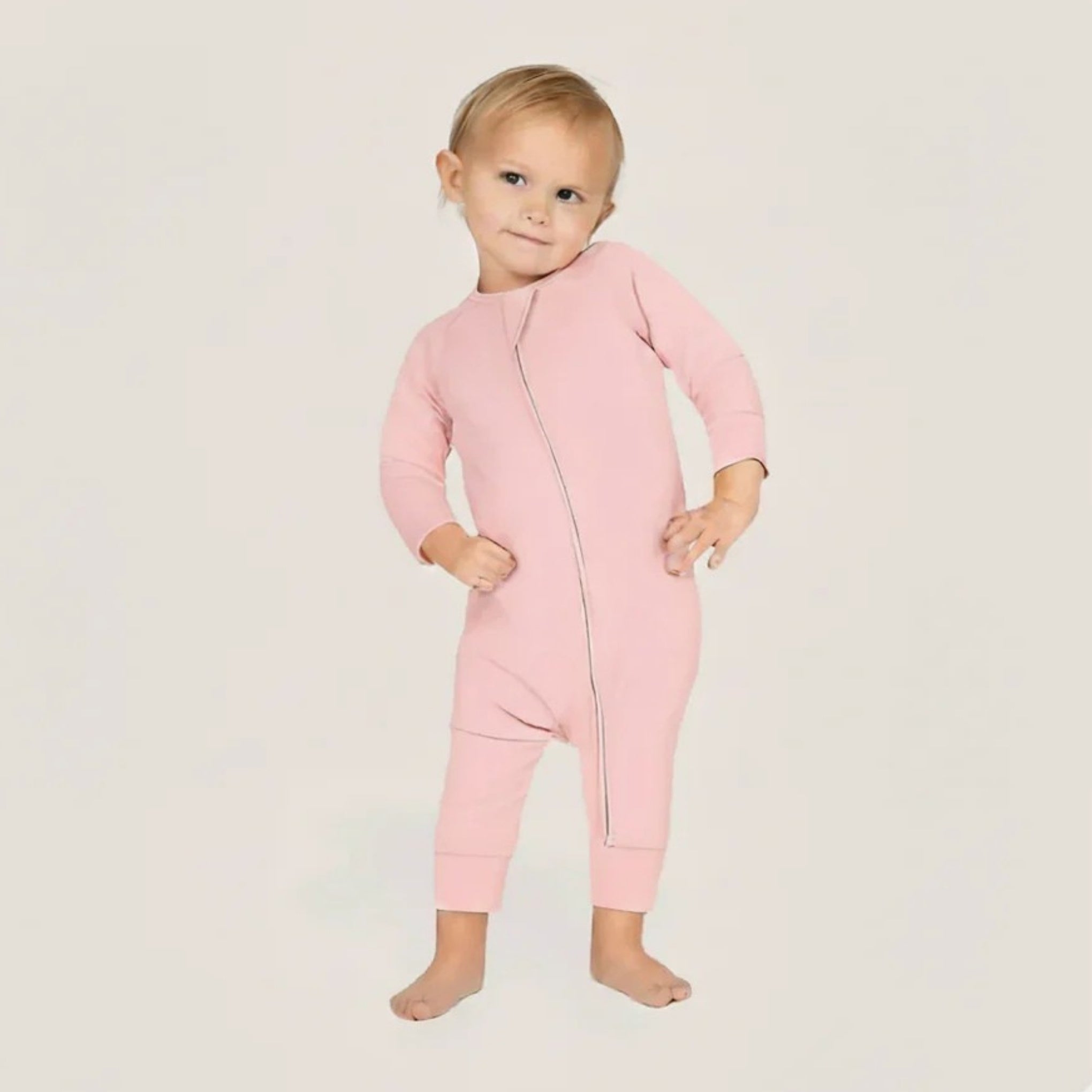 Baby wearing a pink baby grow