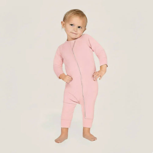 Baby wearing a pink baby grow
