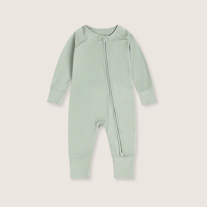Light green baby onesie with a zipper on a light gray background