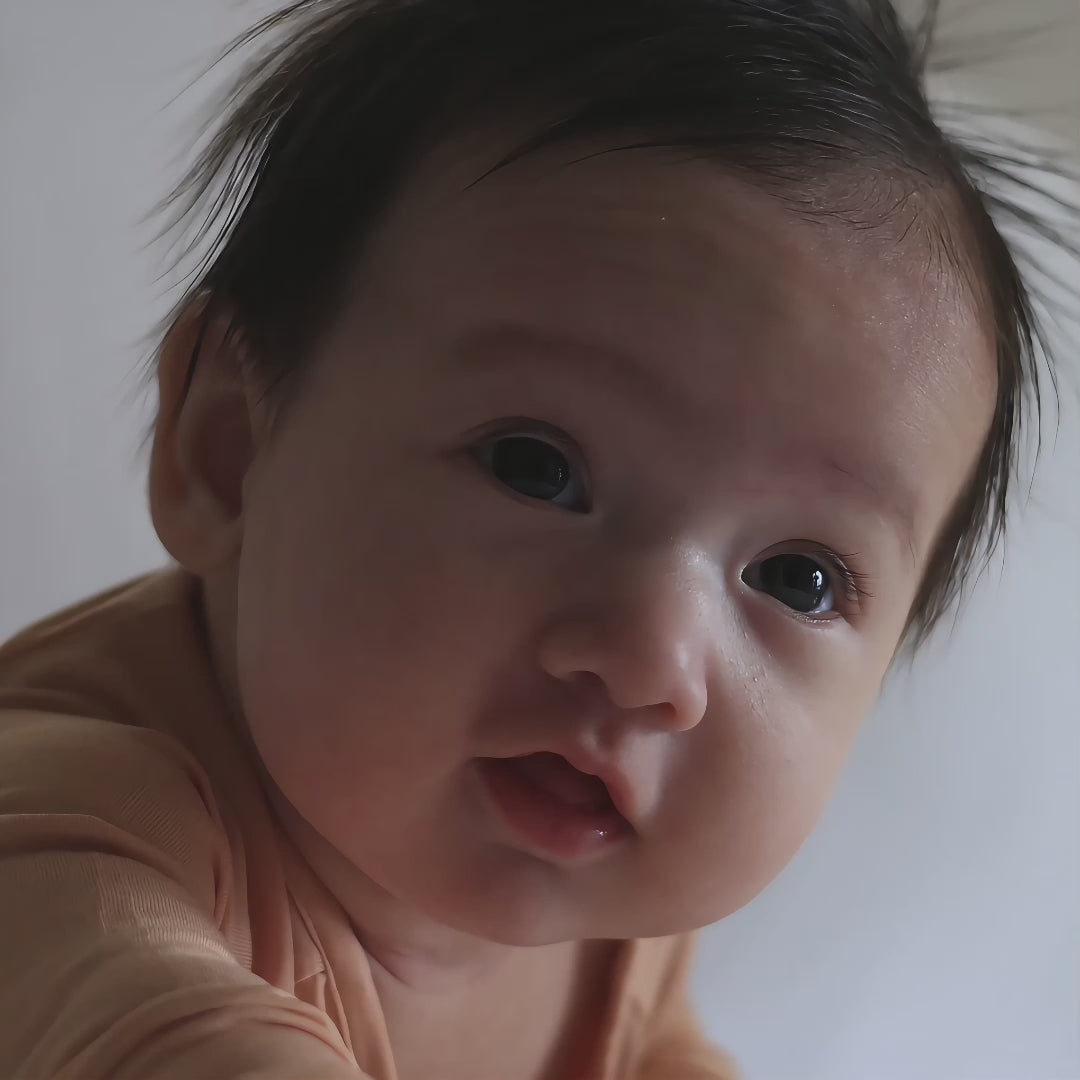 Baby wearing orange pyjama video
