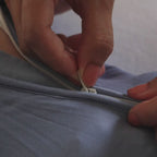 Baby wearing dark blue pyjama being zipped up